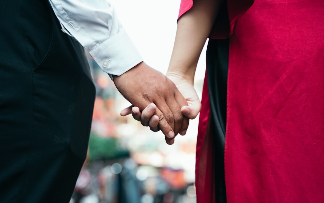 A close up of a person holding the hand of another person